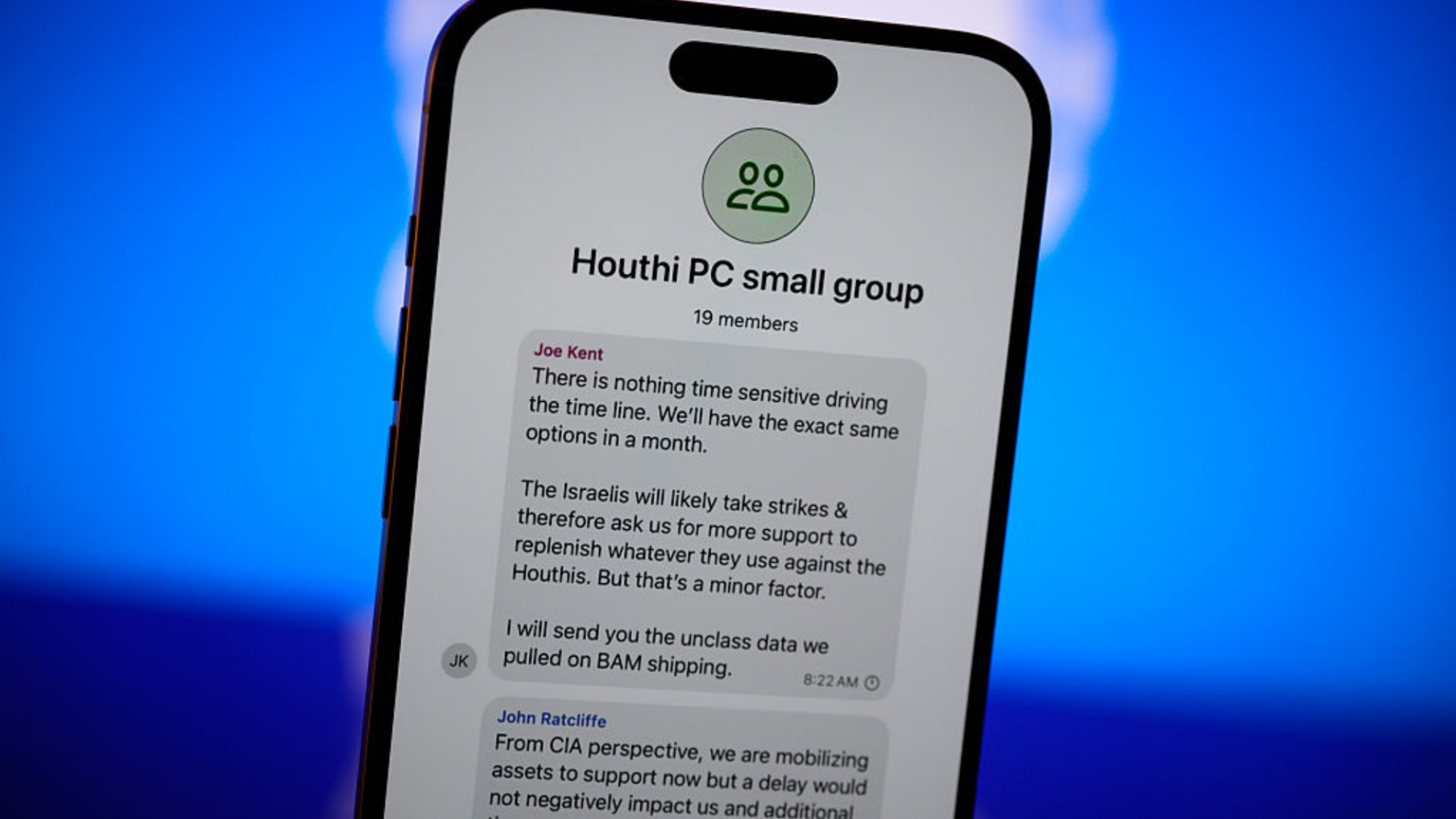 A screenshot of the U.S. official's Signal messages shown on a phone, with the Signal logo in the background.